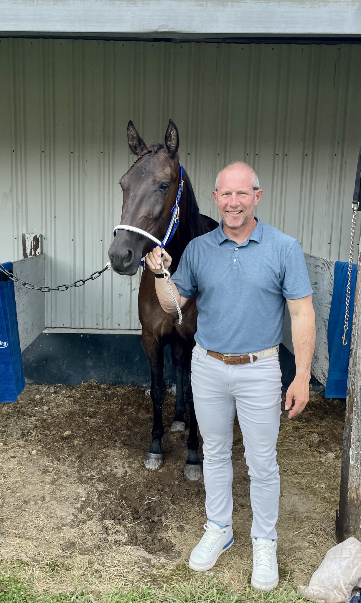 Owner spending time with a horse in the barn